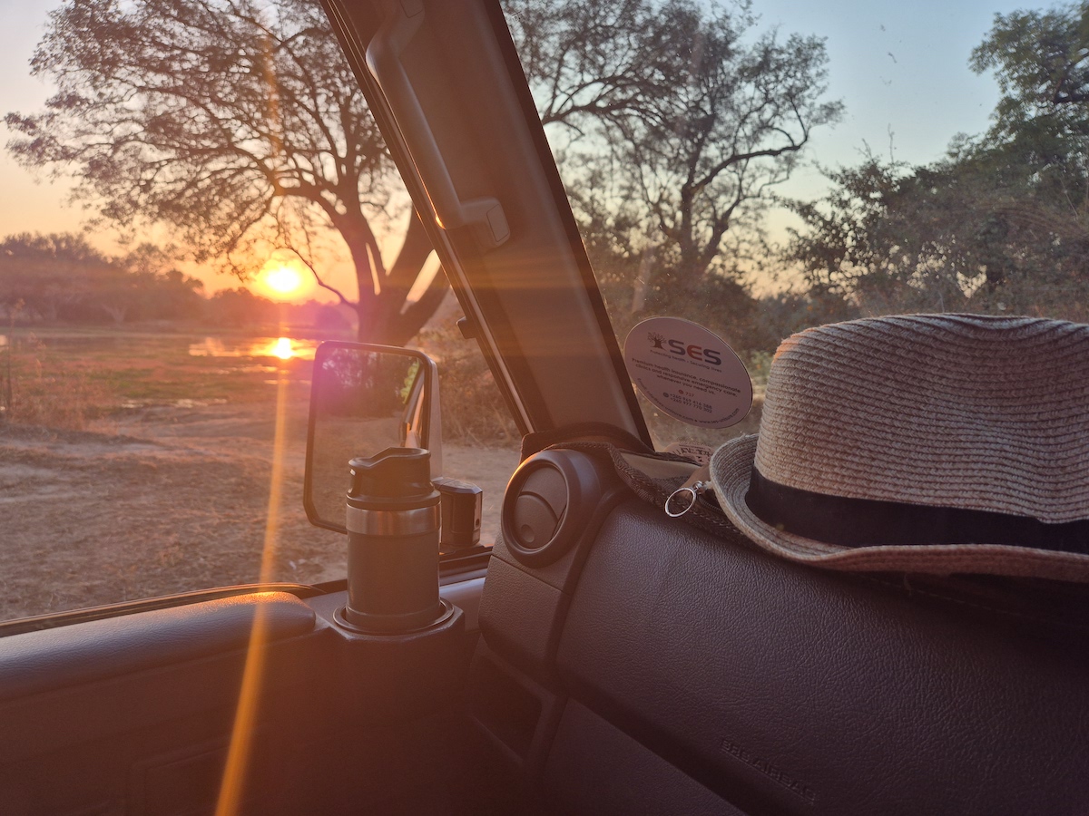 Sunrise over the savanna from the passenger seat of a 4x4