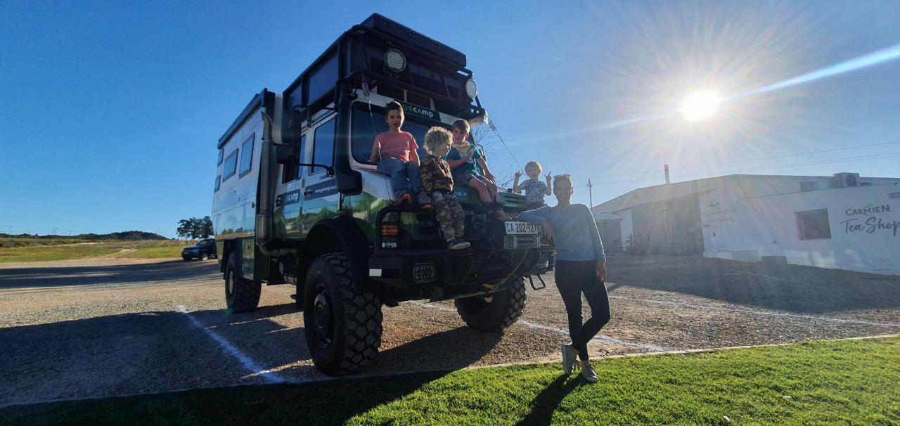 The family with an expedition truck on a sunny stop