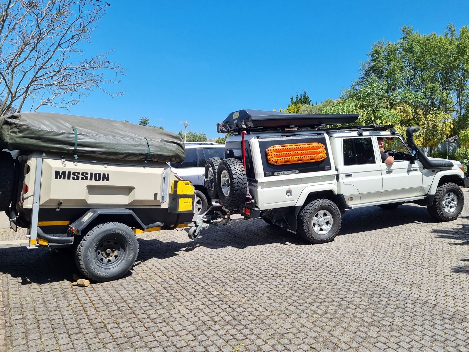 An equipped Land Cruiser towing an off-road camping trailer