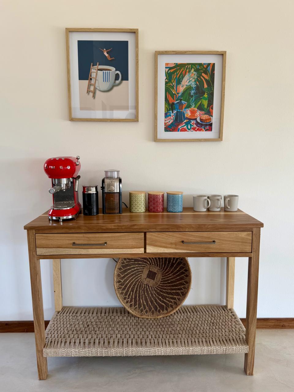 A coffee station with an espresso machine, grinder and ceramic mugs