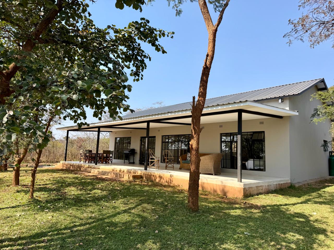 Marula Cottage across the lawn, with the veranda running the length of the house