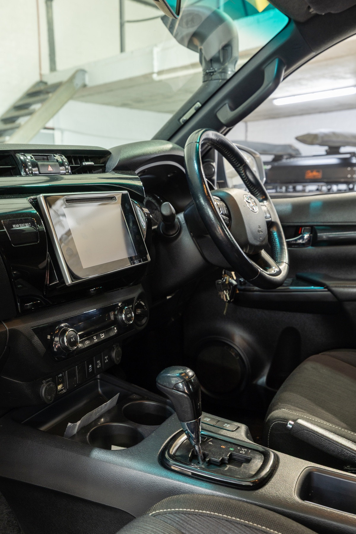 Hilux cabin, showing the steering wheel, infotainment and climate controls